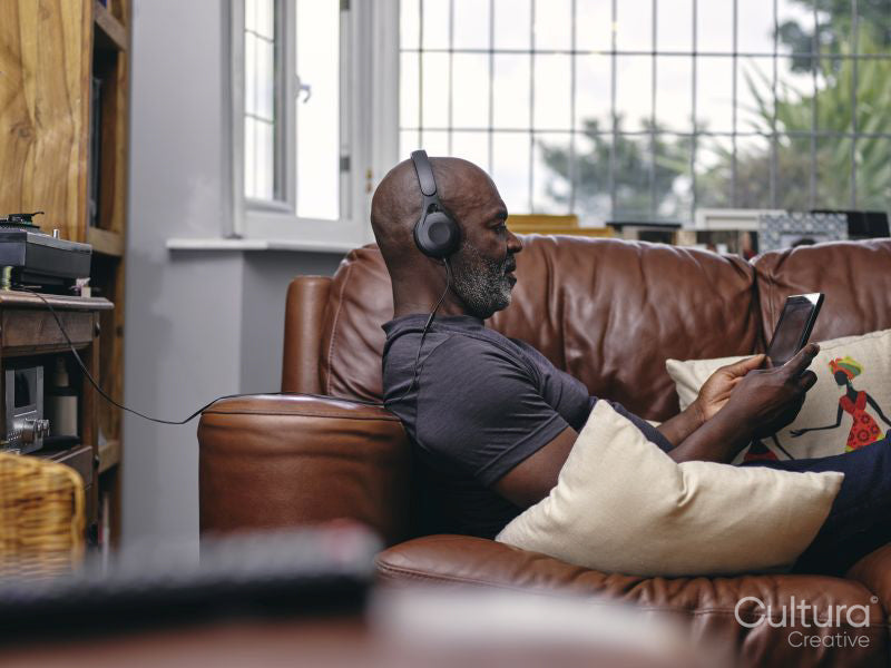 Man listening to music on sofa