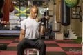 Mature man lifting dumbbells in gym