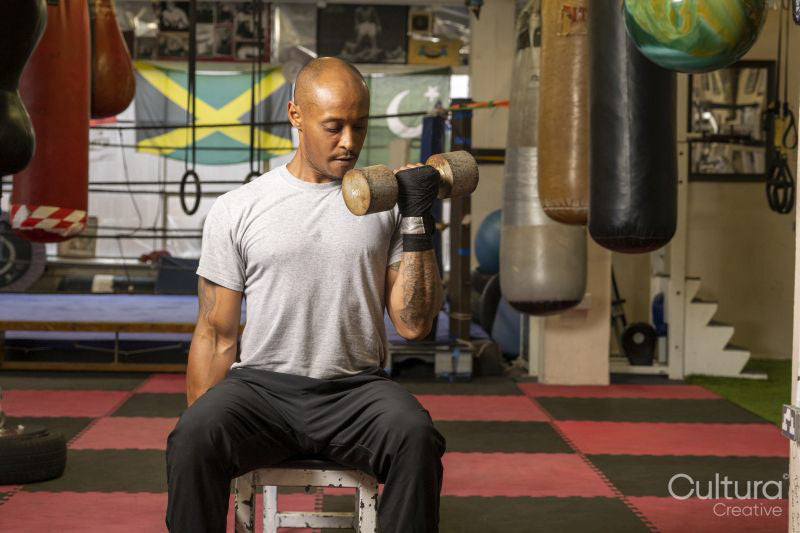 Mature man lifting dumbbells in gym
