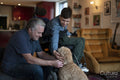 Father and disabled son cuddling dog