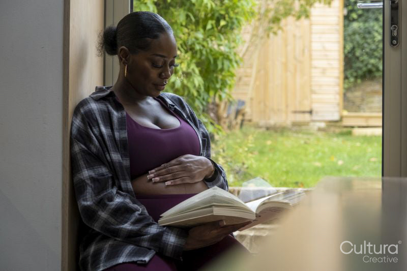 Pregnant woman reading book