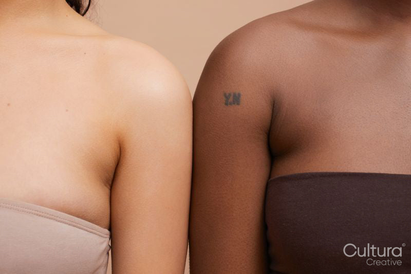 Studio portrait of diverse women arm in arm