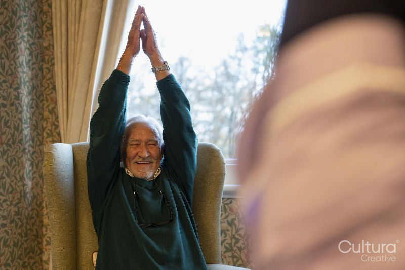 Smiling senior man exercising in nursing home