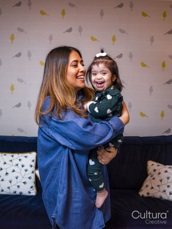 Smiling mother holding daughter