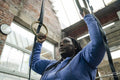 Woman exercising on gymnastic rings in gym