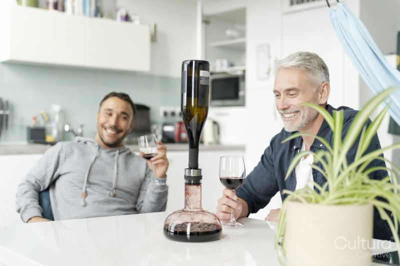 Male couple using wine breather decanter at home