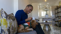 Man with dog sitting on sofa