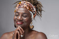 Studio shot of smiling mature woman in headscarf