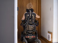 Woman in electric wheelchair going through automatic doors