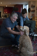 Father and disabled son cuddling dog