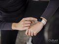 Close-up of athlete woman checking smart watch