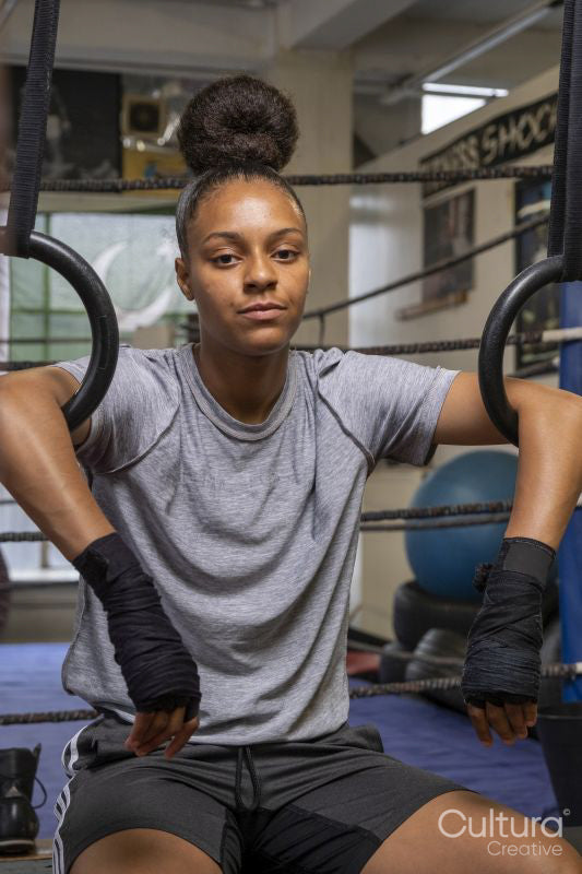 Young woman exercising at gym, portrait