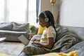 Girl using laptop on sofa