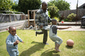 Father with Down syndrome playing soccer with sons