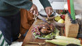 Father cutting chicken for children during Kwanzaa meal