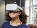 Girl with Down Syndrome wearing VR goggles