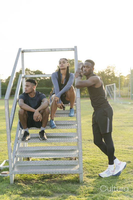 Group of athletes sitting on steps at stadium