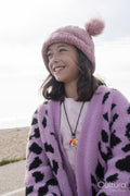 Portrait of smiling girl on beach on cloudy day