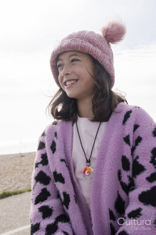 Portrait of smiling girl on beach on cloudy day