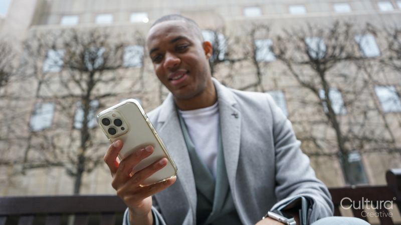 Business man using phone outside office building