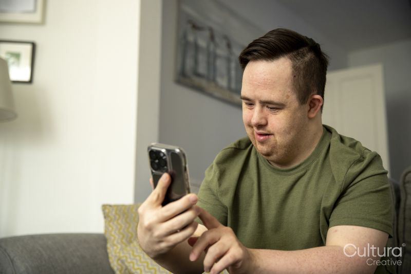 Man sitting on sofa and using smart phone