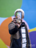 Portrait of man taking selfie against colorful wall