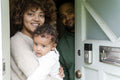 Parents with baby daughter at home entrance