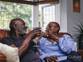 Couple sitting on sofa and drinking wine