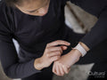 Close-up of athlete woman checking smart watch