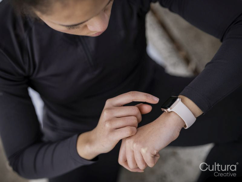 Close-up of athlete woman checking smart watch