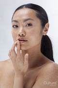 Studio portrait of woman touching lips