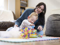 Mother looking at son playing with toys