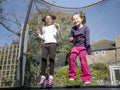 Girl friends jumping on trampoline