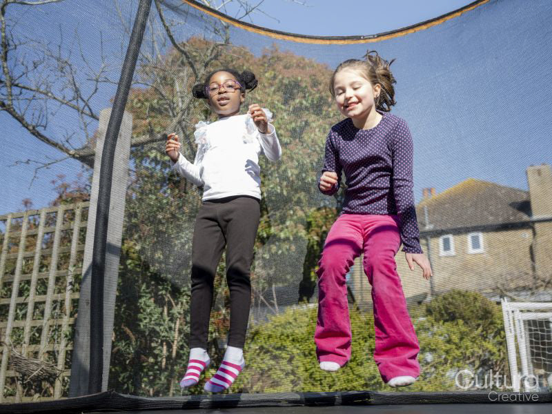 Girl friends jumping on trampoline