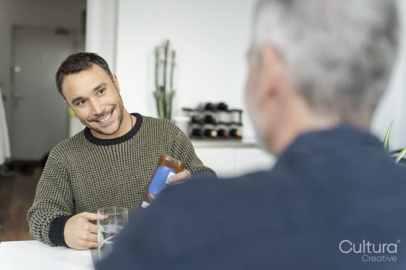 Male couple eating breakfast at home