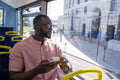 Man with smart phone sitting in bus