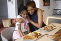 Mother and daughter enjoying dinner at home