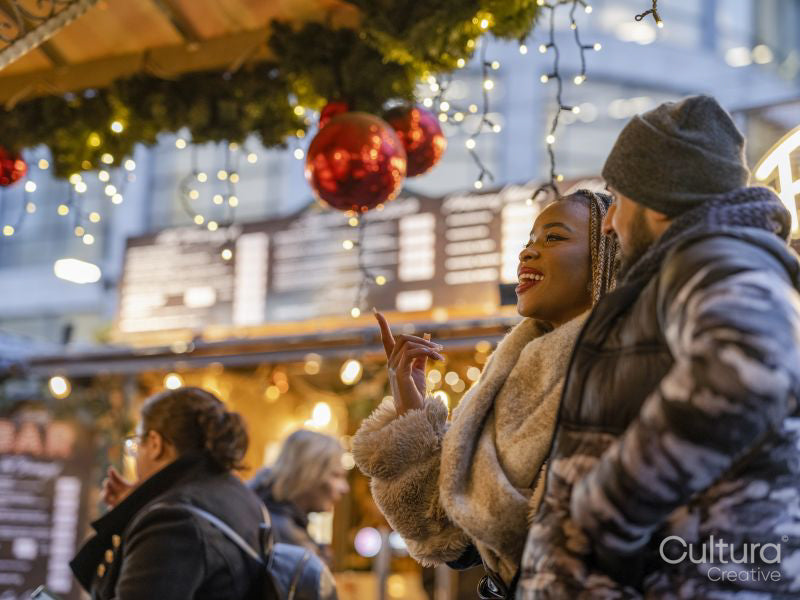 Smiling young couple at Christmas market