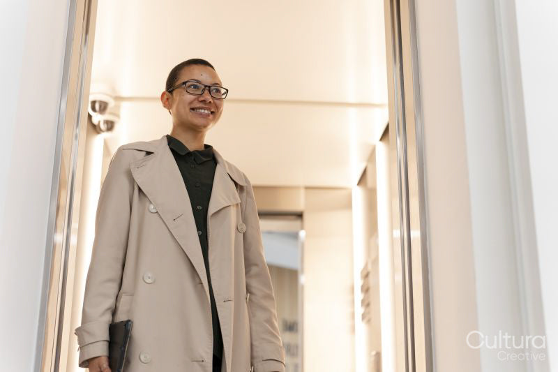 Non binary office worker walking in hallway