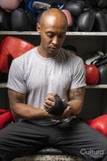Mature man wrapping hands for boxing match