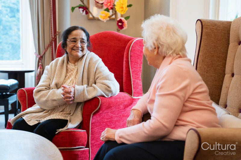 Senior women sitting in armchairs and talking together
