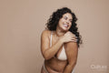 Studio shot of smiling young woman wearing lingerie