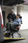 Father and disabled son using wheelchair lift