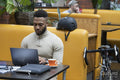 Man sitting in office lounge using laptop