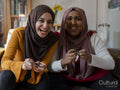 Smiling women playing video game at home