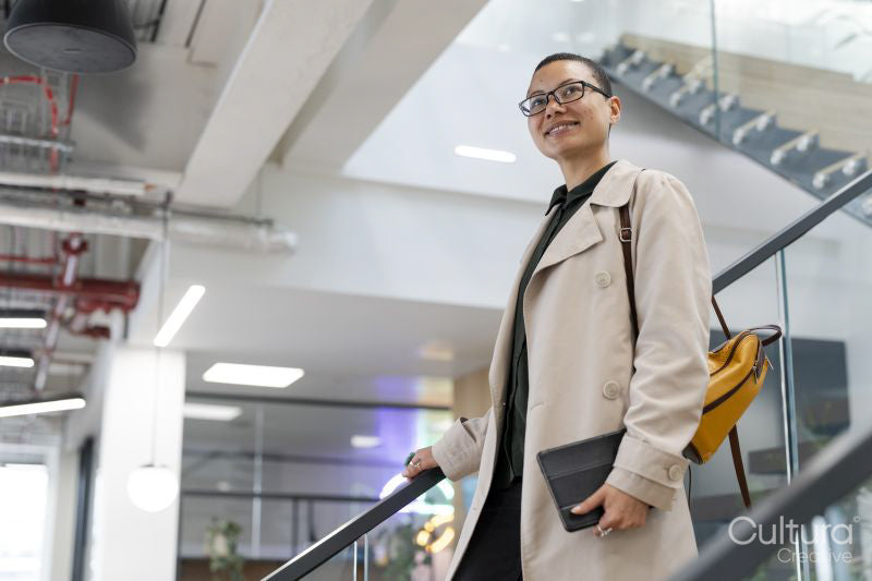 Non binary office worker walking on steps
