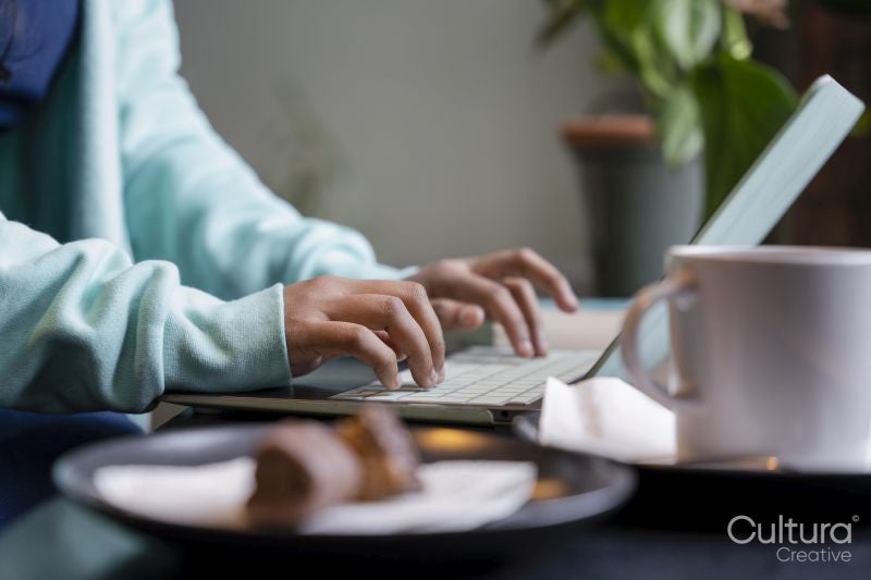 Female student using laptop while studying