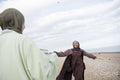 Two Muslim women greeting on beach