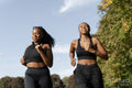 Young female friends jogging in park