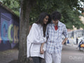 Female couple holding hands in street